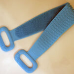 A bright blue silicone back scrubber