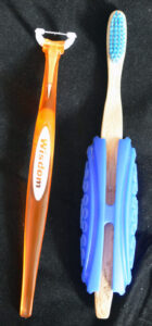 A long handled "easy flosser" and a bamboo toothbrush in a bright blue plastic grip